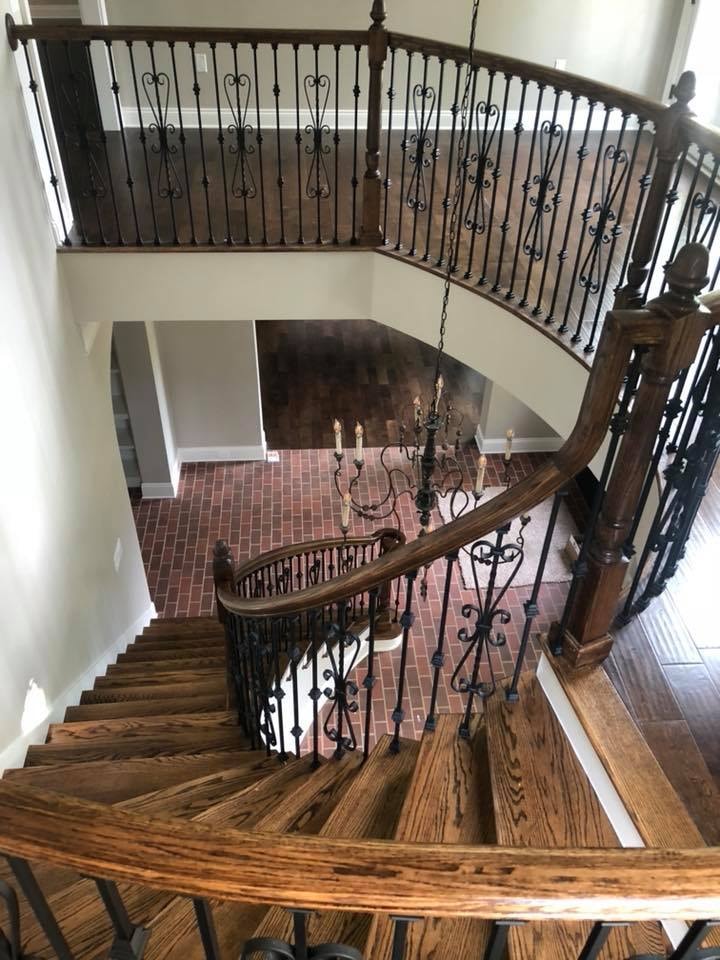 Aerial view of curved staircase with wrought-iron railings