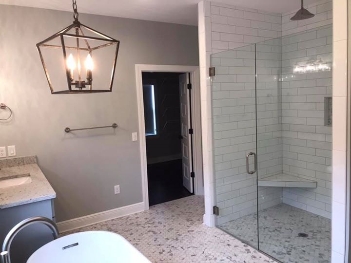 Master bath with lantern pendant, clawfoot tub, subway tile glass shower and granite floor