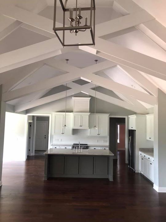 Dramatic vaulted X-beam ceiling over open kitchen and living area