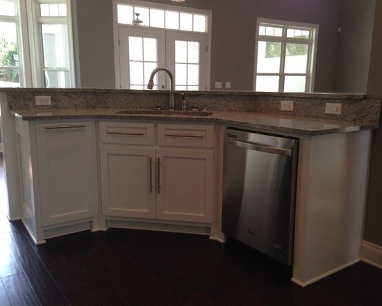 Curved white shaker island with granite counter, stainless dishwasher, French doors and dark hardwood