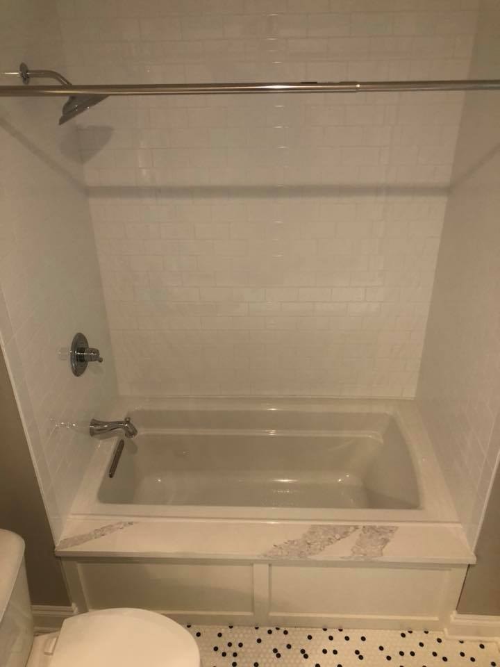Guest bath with soaking tub and white subway tile surround