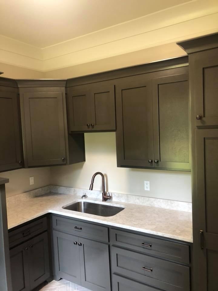 Kitchen with olive-gray shaker cabinets, quartz counters and stainless sink