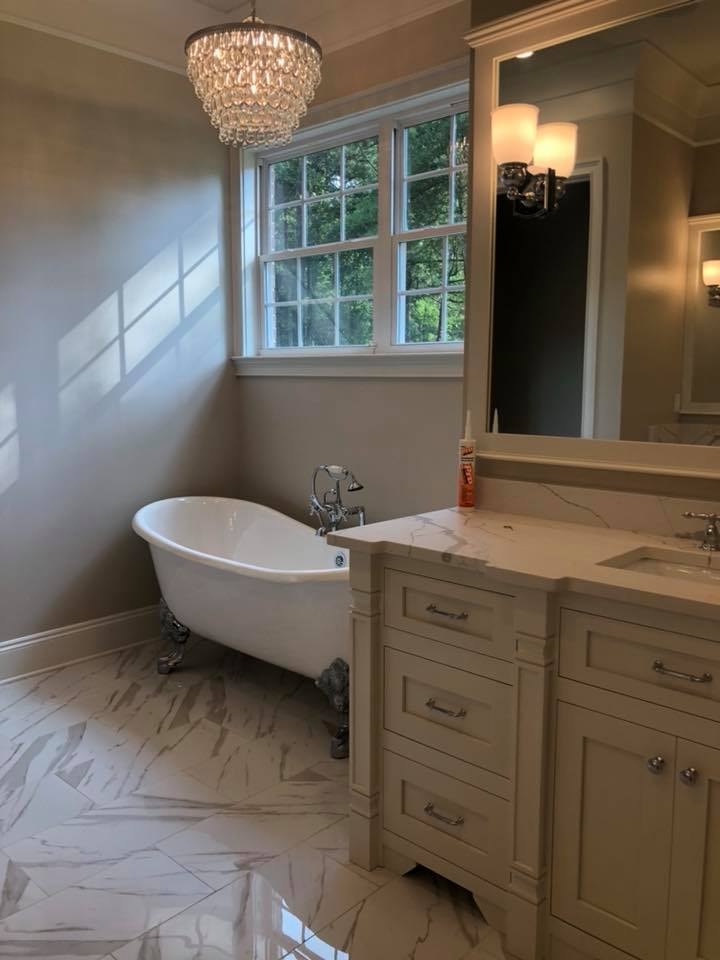 Master bath with clawfoot tub, crystal chandelier and marble floors