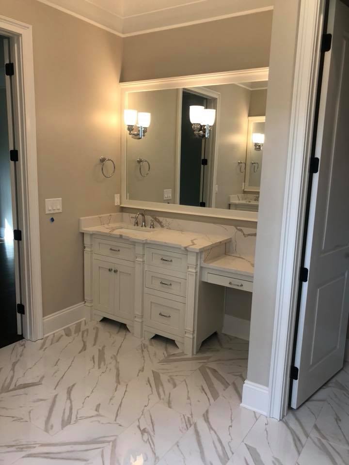 Master bath vanity with marble countertop and custom cabinetry