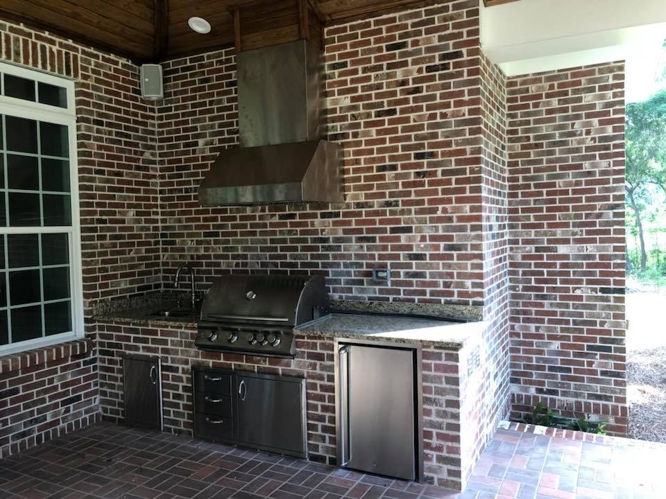 Brick outdoor kitchen with stainless grill and granite counters